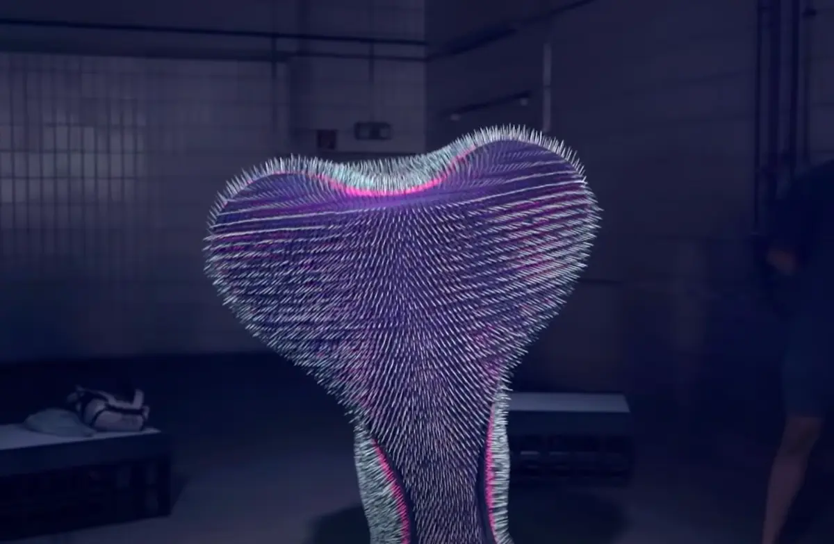 A spiky, heart-like form illuminated with purple and magenta light sits in the center of a dimly lit room. The room has white tiled walls that reflect the ethereal glow of the sculpture.