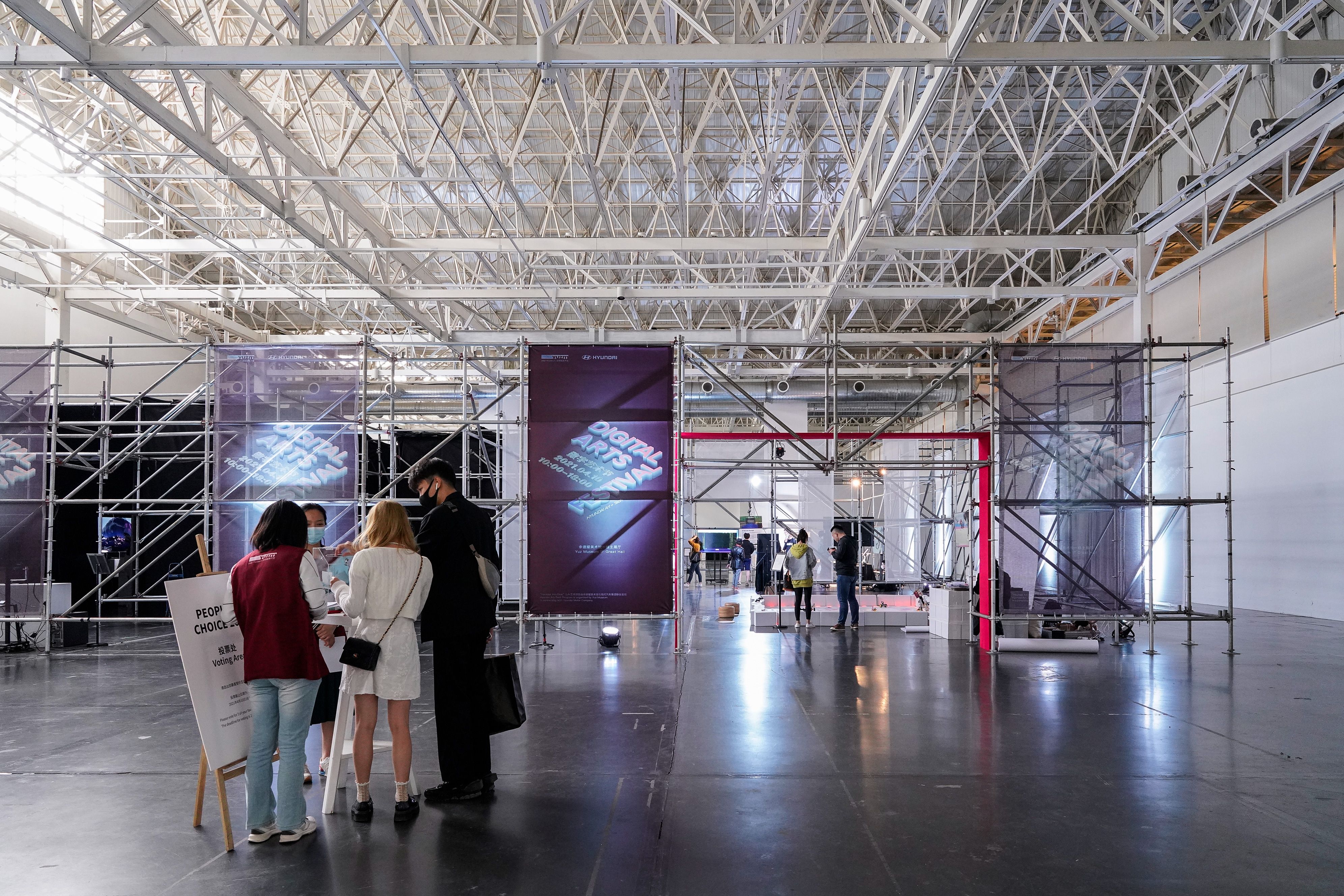 People exploring a gallery hall with event posters displayed during Hyundai Art+Tech Digital Arts Festival at Yuz Museum, ...