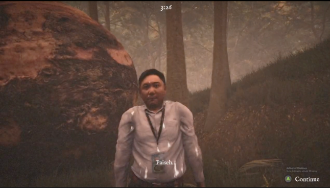 A man in office attire with an ID lanyard stands before a massive fallen rock in a dim forest.
