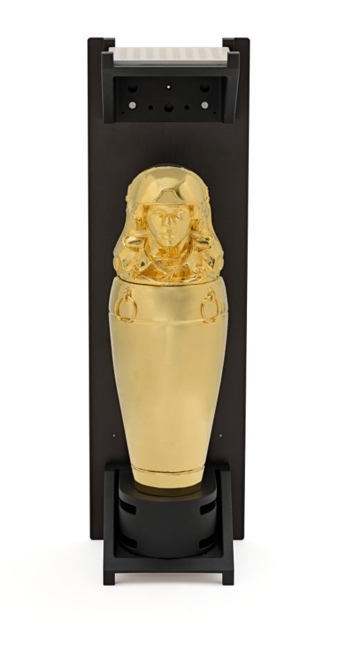 A gold statue displayed in a black casing, emanating a striking contrast that accentuates its intricate design and glossy ...