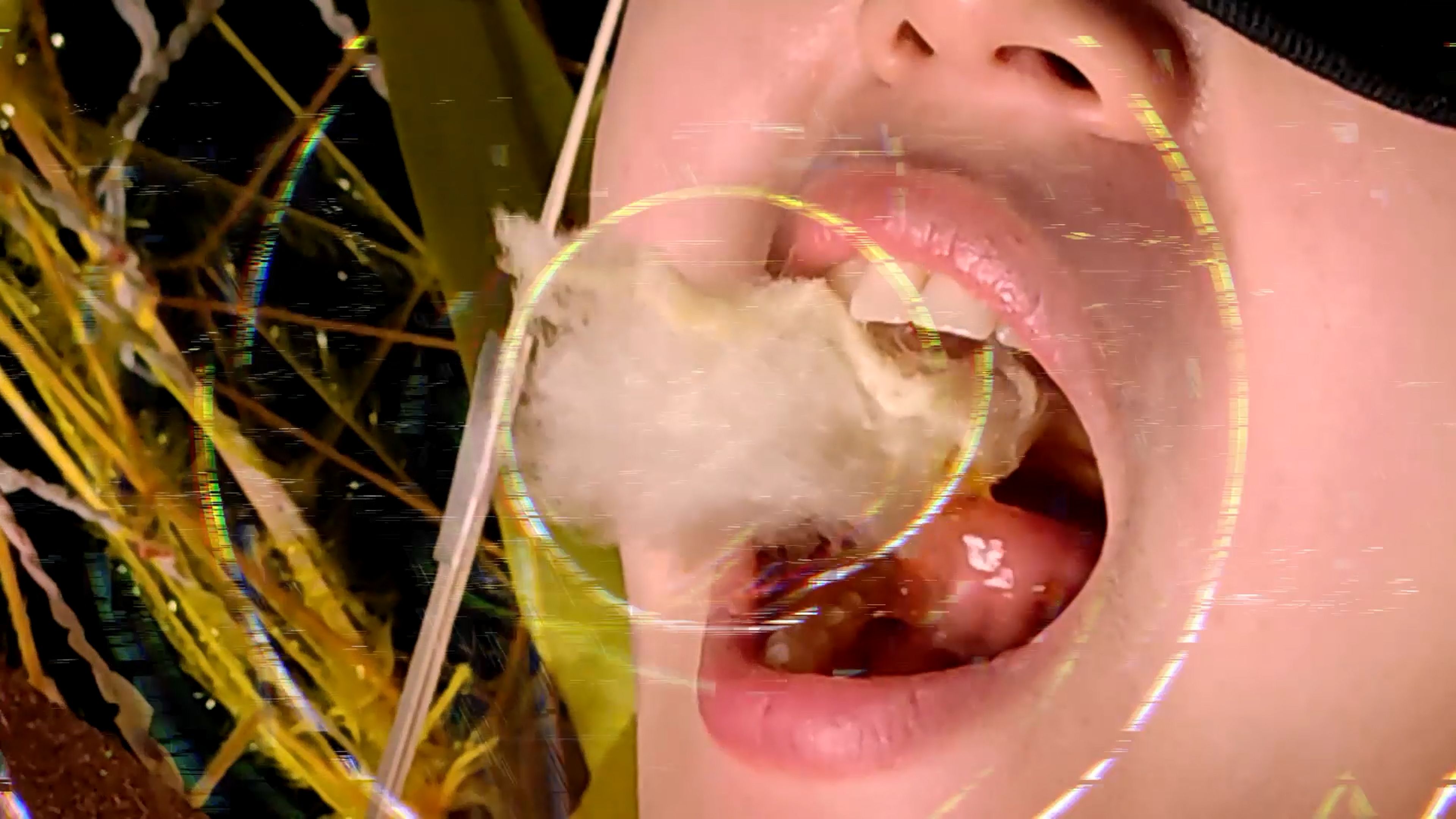 A graphic depiction of an open mouth consuming pink cotton candy, embellished with surrounding abstract line shapes.