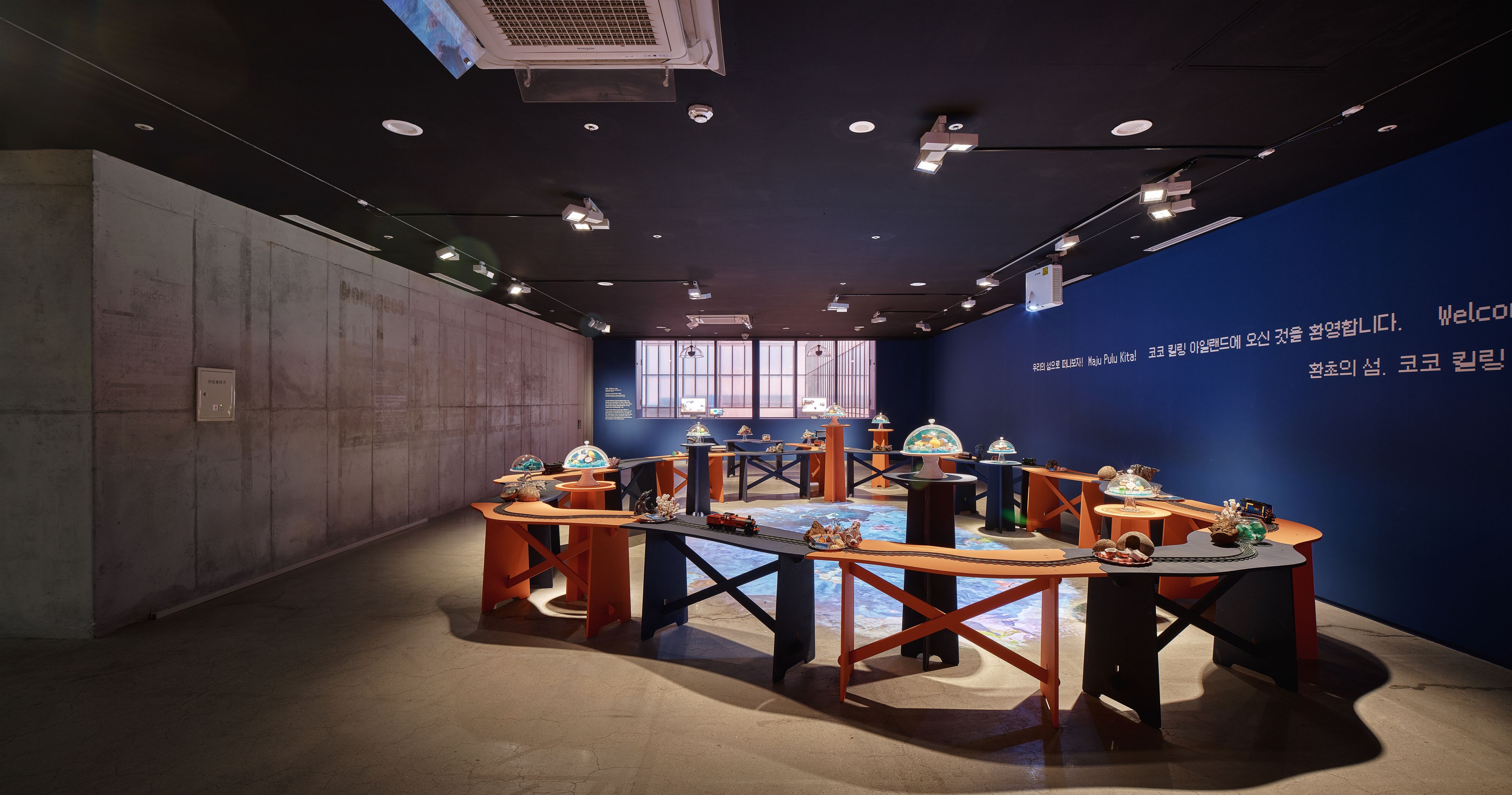An arrangement of tables forming a circular shape during an event. The artwork, titled 'Crypton, Atoll, 2022', is a mixed ...