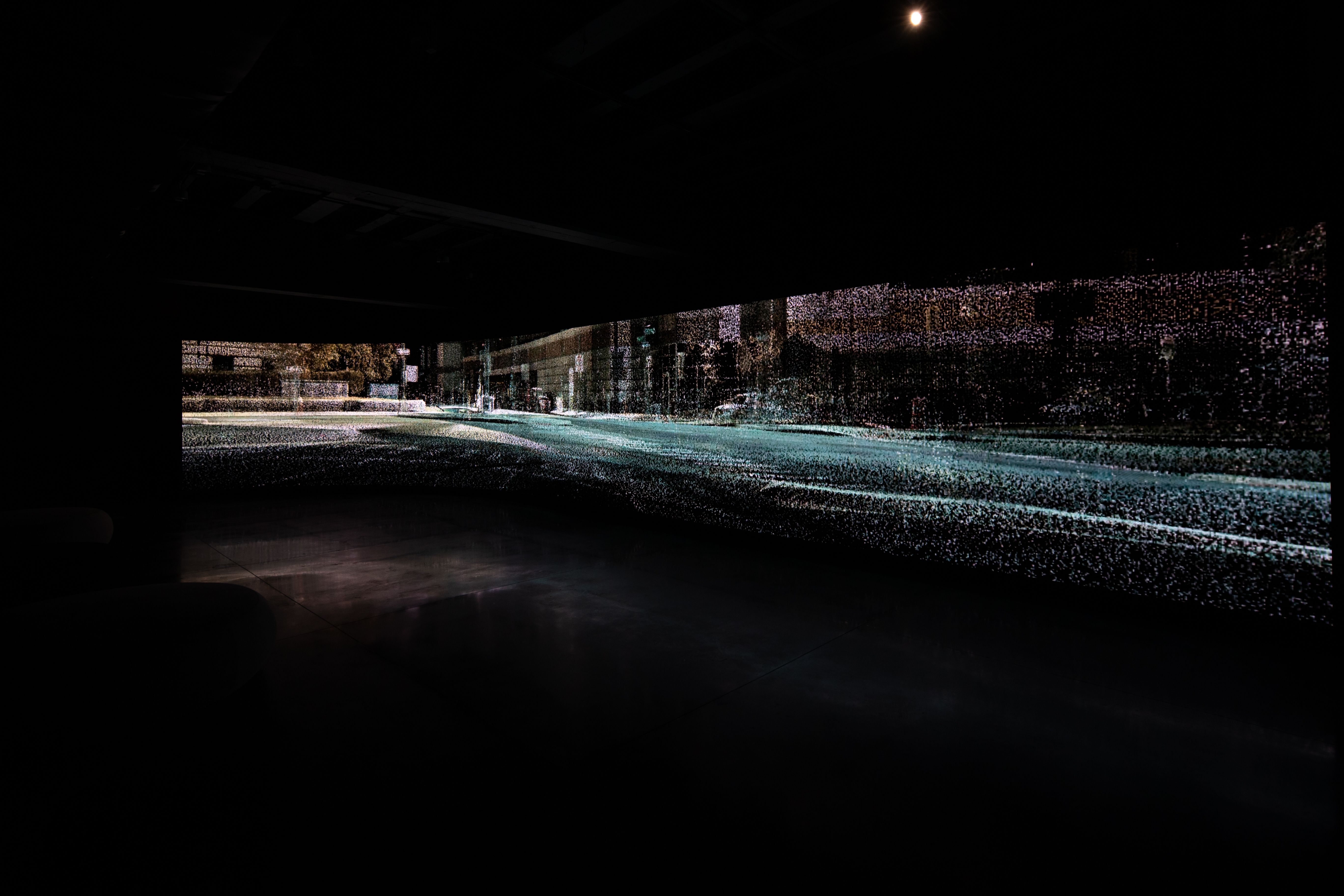 An artistic, blurry photograph capturing a cityscape on a rainy night, the road lined with indistinct buildings highlighte...