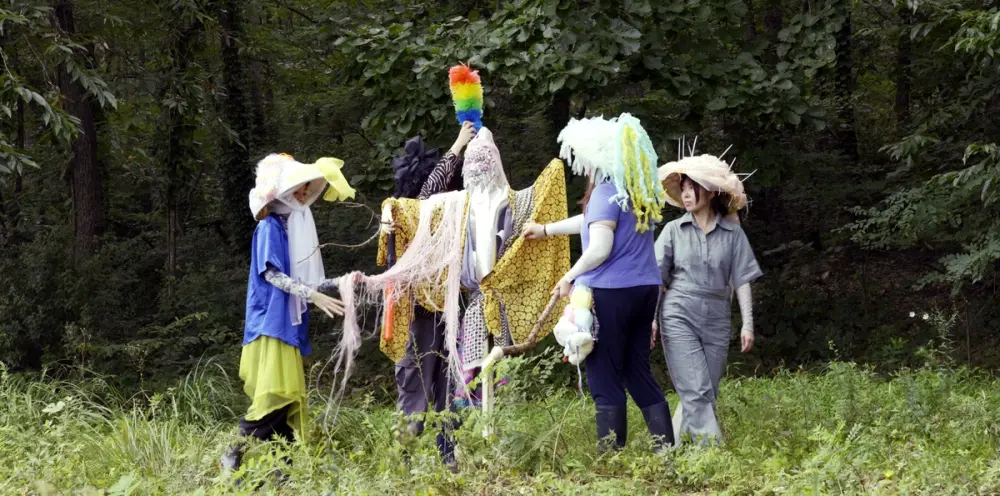 lab B surrounds a scare crow in a field.