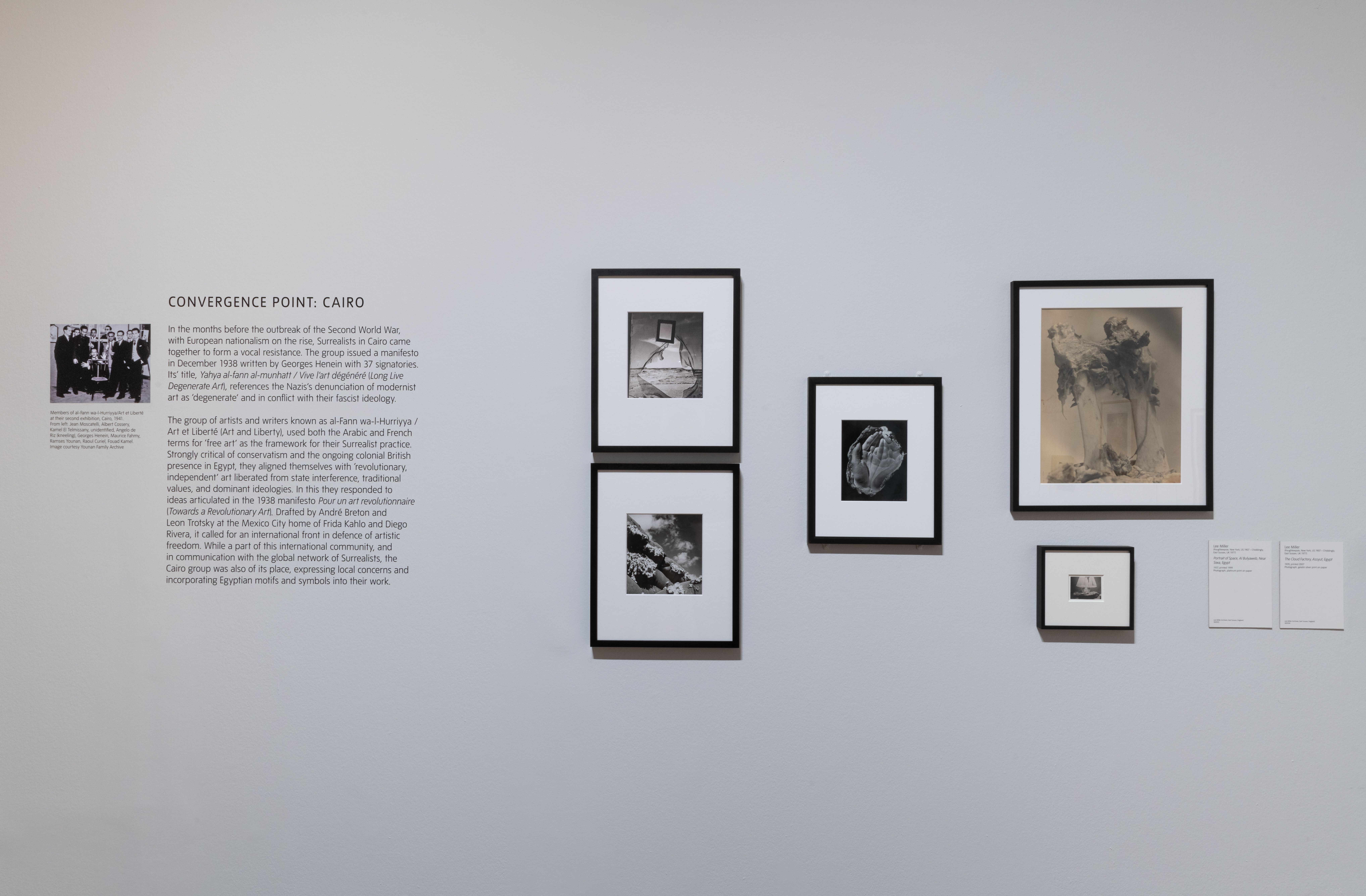 Various sized framed artworks hung on a white wall, labeled "Convergence point: Cairo".