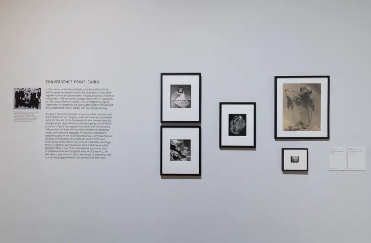 Various sized framed artworks hung on a white wall, labeled "Convergence point: Cairo".