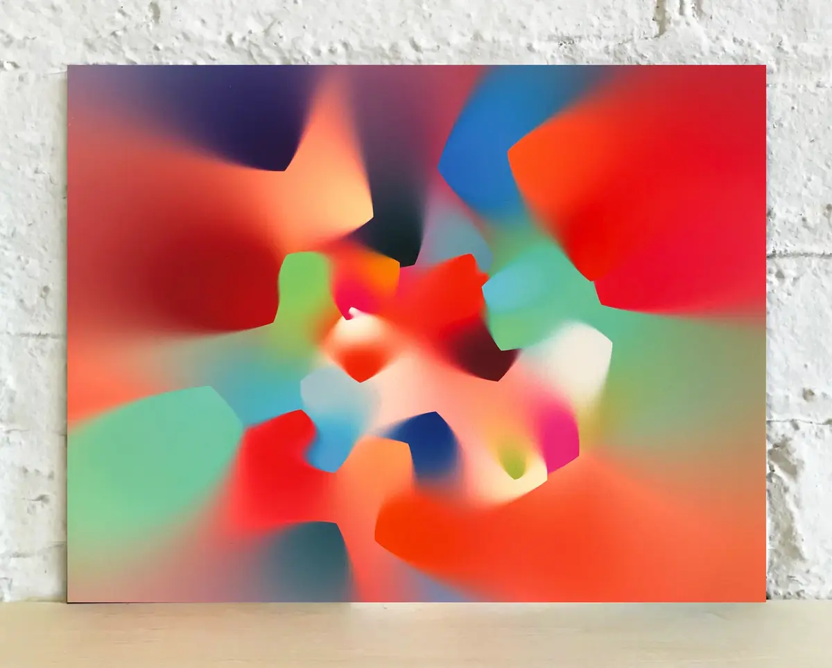A smudged, kaleidoscopic print leaning against a wall, featuring gradient swirls of color.