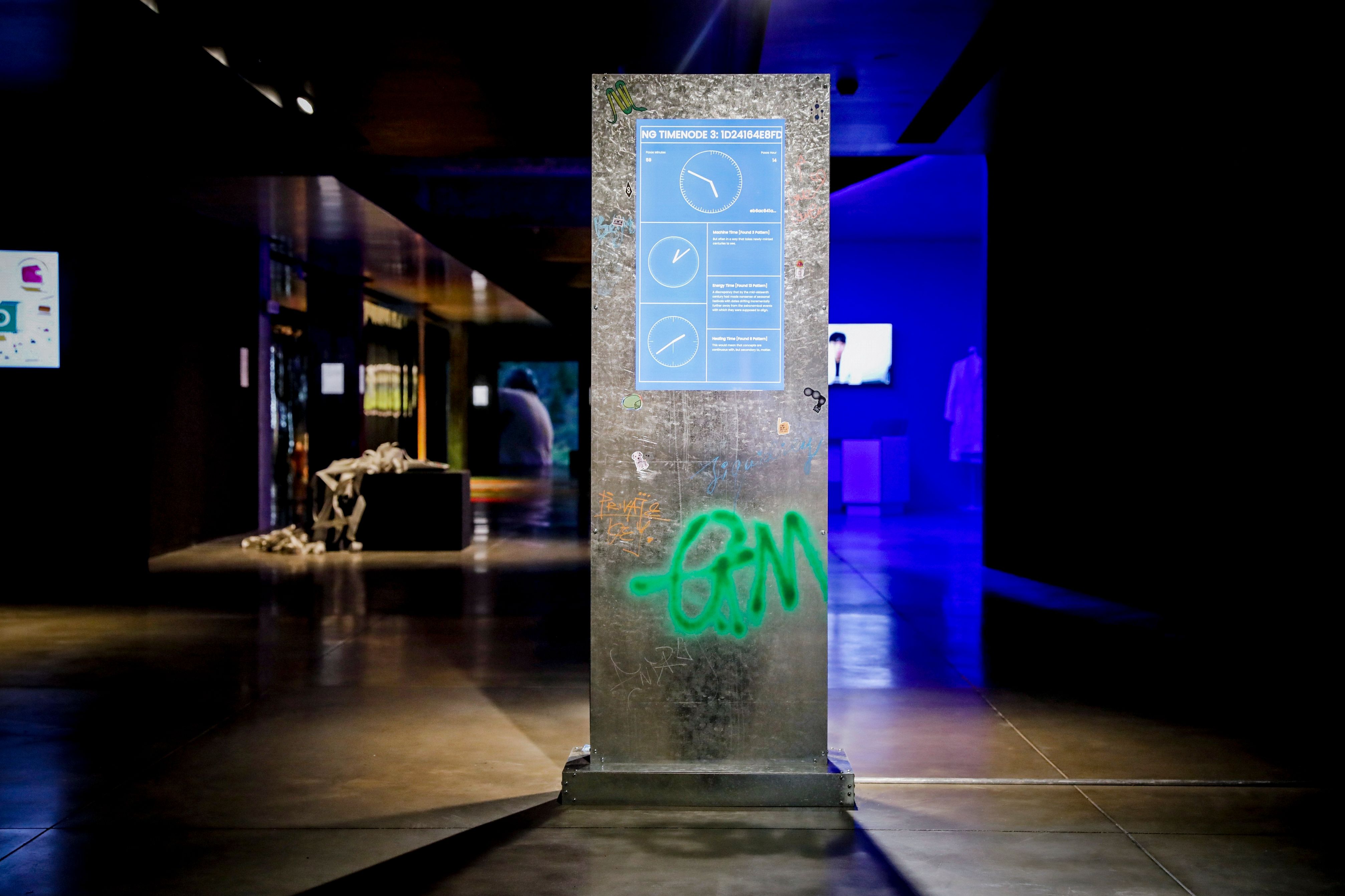 Interactive art piece featuring a standing screen with blue-toned information.