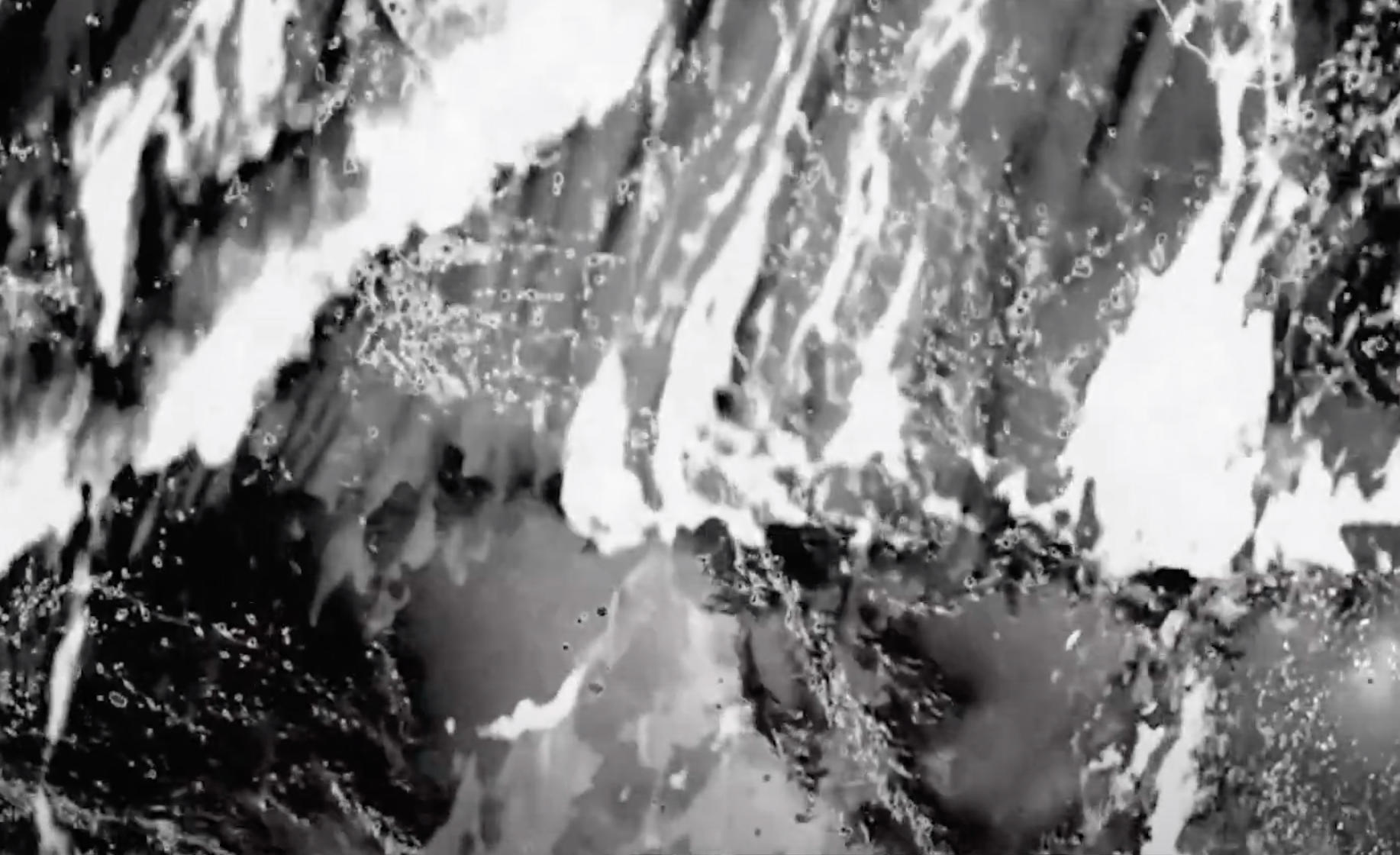 A black and white photograph featuring indiscernible shapes, suggestive of a scientific or artistic exploration.
