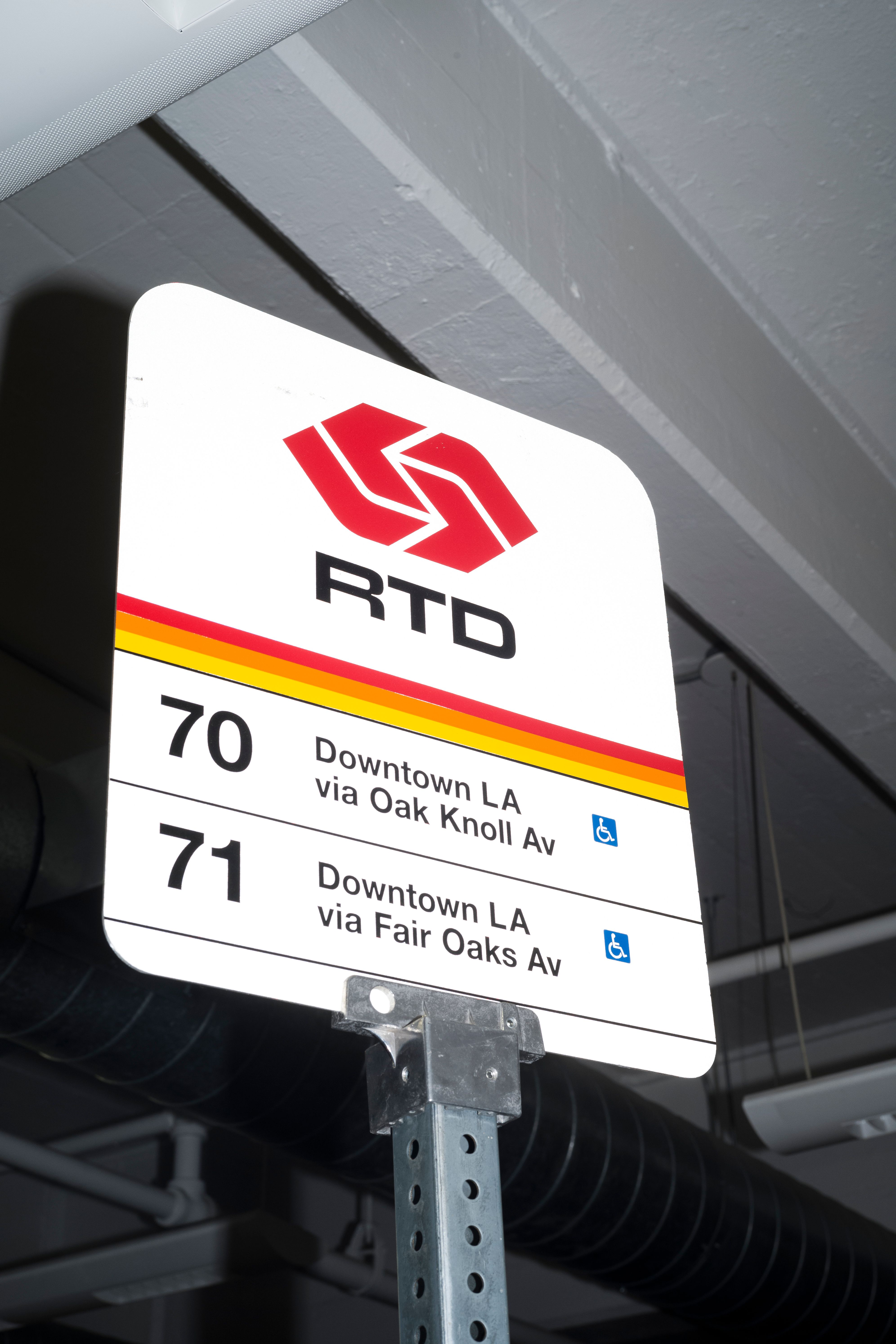 RTD bus stop sign indoors for routes 70 and 71 to Downtown LA.