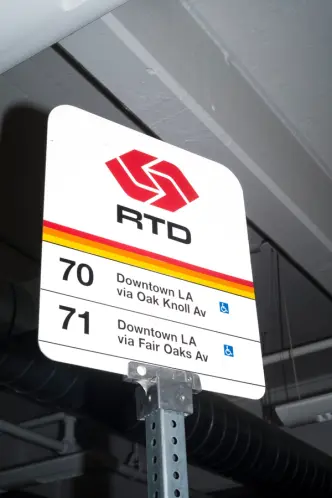 RTD bus stop sign indoors for routes 70 and 71 to Downtown LA.