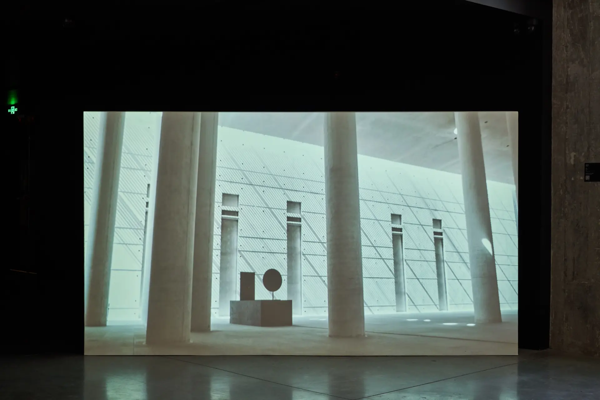 Projection in a dark room of pillars and geometric structures.