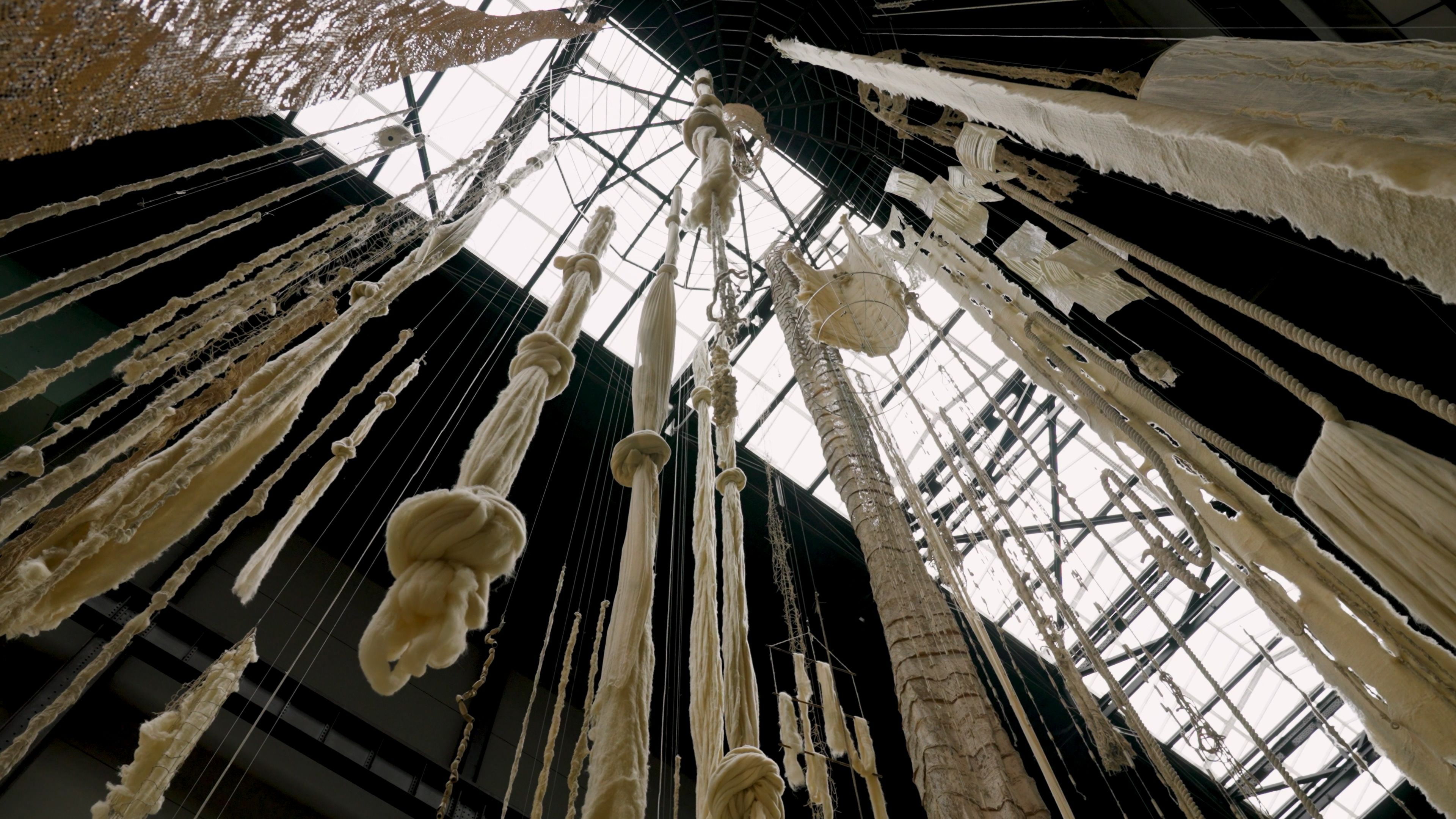 A view from below of hanging white fabric.