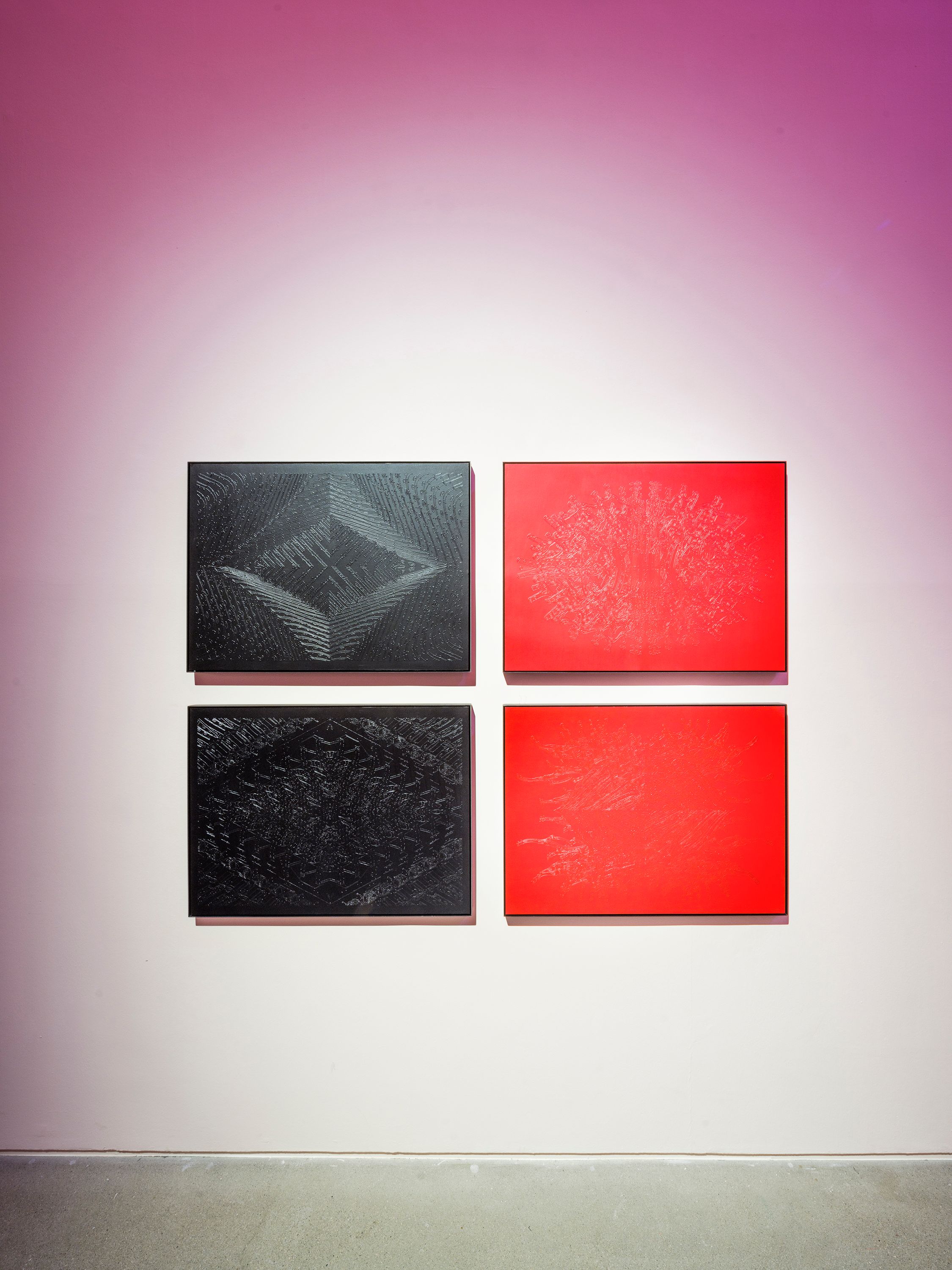 Four patterned art pieces arranged in two vertical columns on a wall transitioning from white to pink. The top pieces are ...