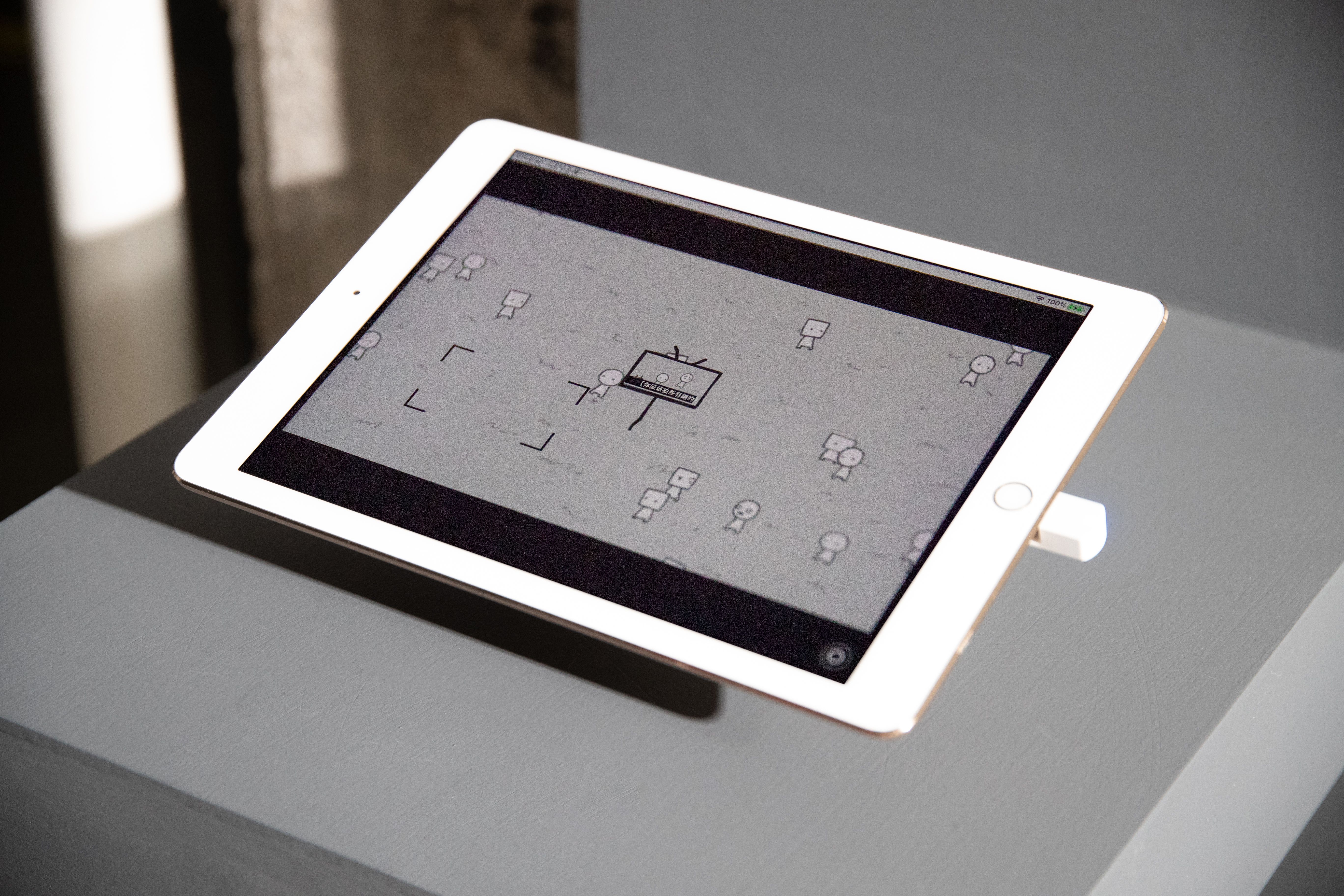 Close-up of a tablet displaying a minimalist black and white drawing.