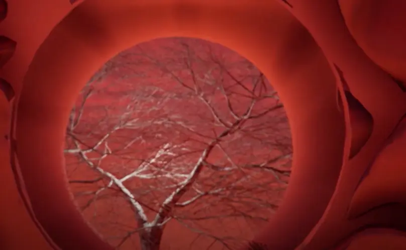 An illuminated tree can be seen through a circular opening in a bold, red architectural structure. The vibrant red sky in ...