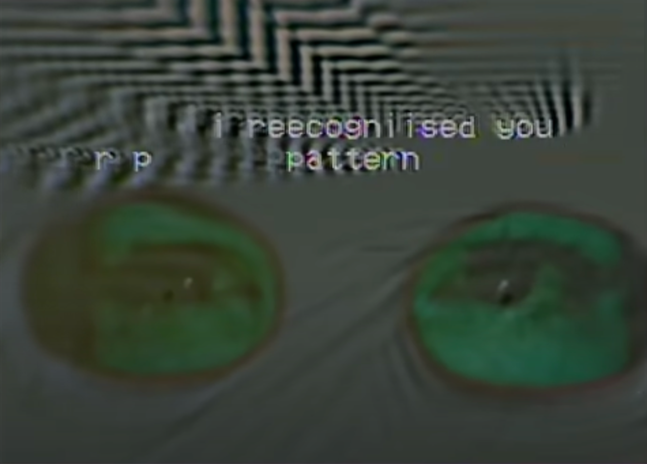 A distorted image showcasing eyes peering through green eyeglass lenses with overlaying text.