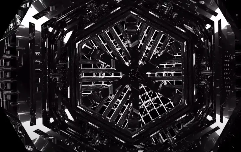 A massive, black iron portal with rivets and paneling stands in an industrial setting. It showcases an intricate design, a...