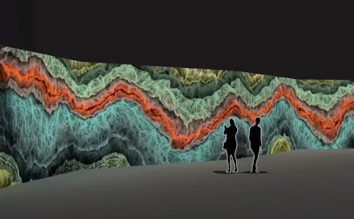 An expansive art graphic depicting waves in shades of green, aqua blue, and orange stretches along a wall. The grey floor contrasts with the vibrant art. Two human silhouettes are partially visible, blending into the scene.