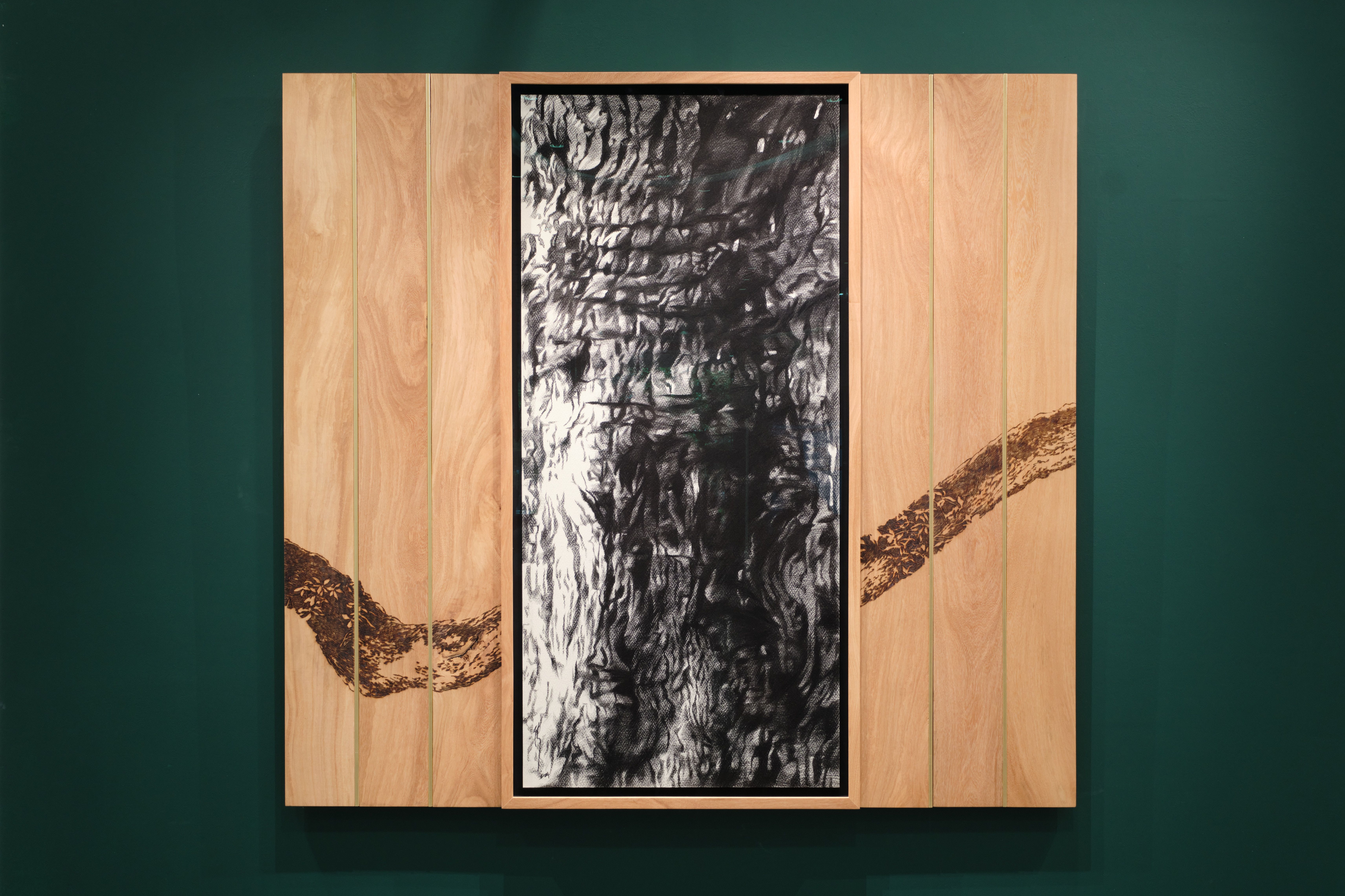 Abstract charcoal-like drawing in a wooden frame with a dark wavy line across the panels.