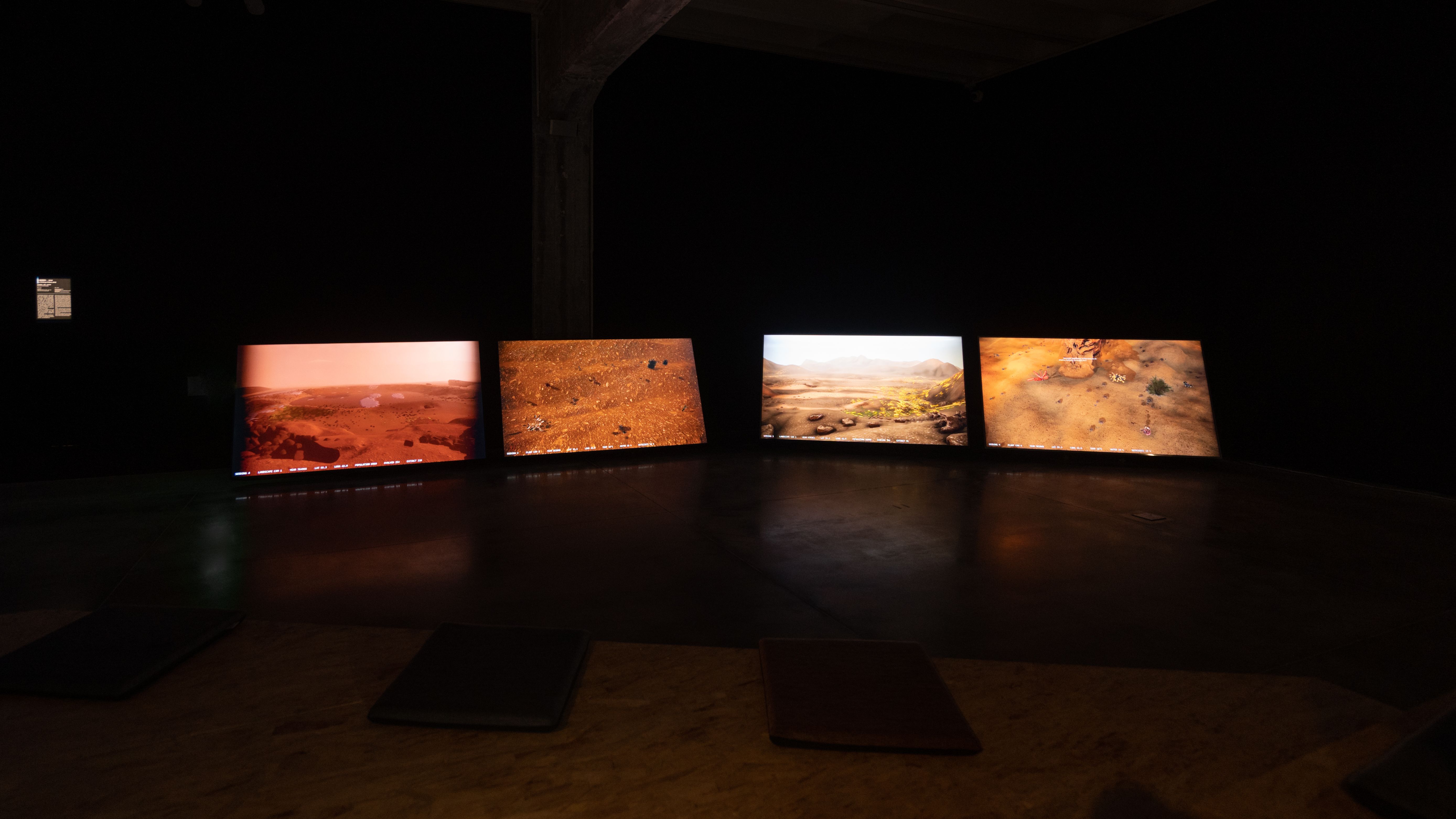 Panoramic view of an exhibit showing Martian landscapes on multiple screens.
