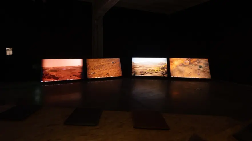Panoramic view of an exhibit showing Martian landscapes on multiple screens.