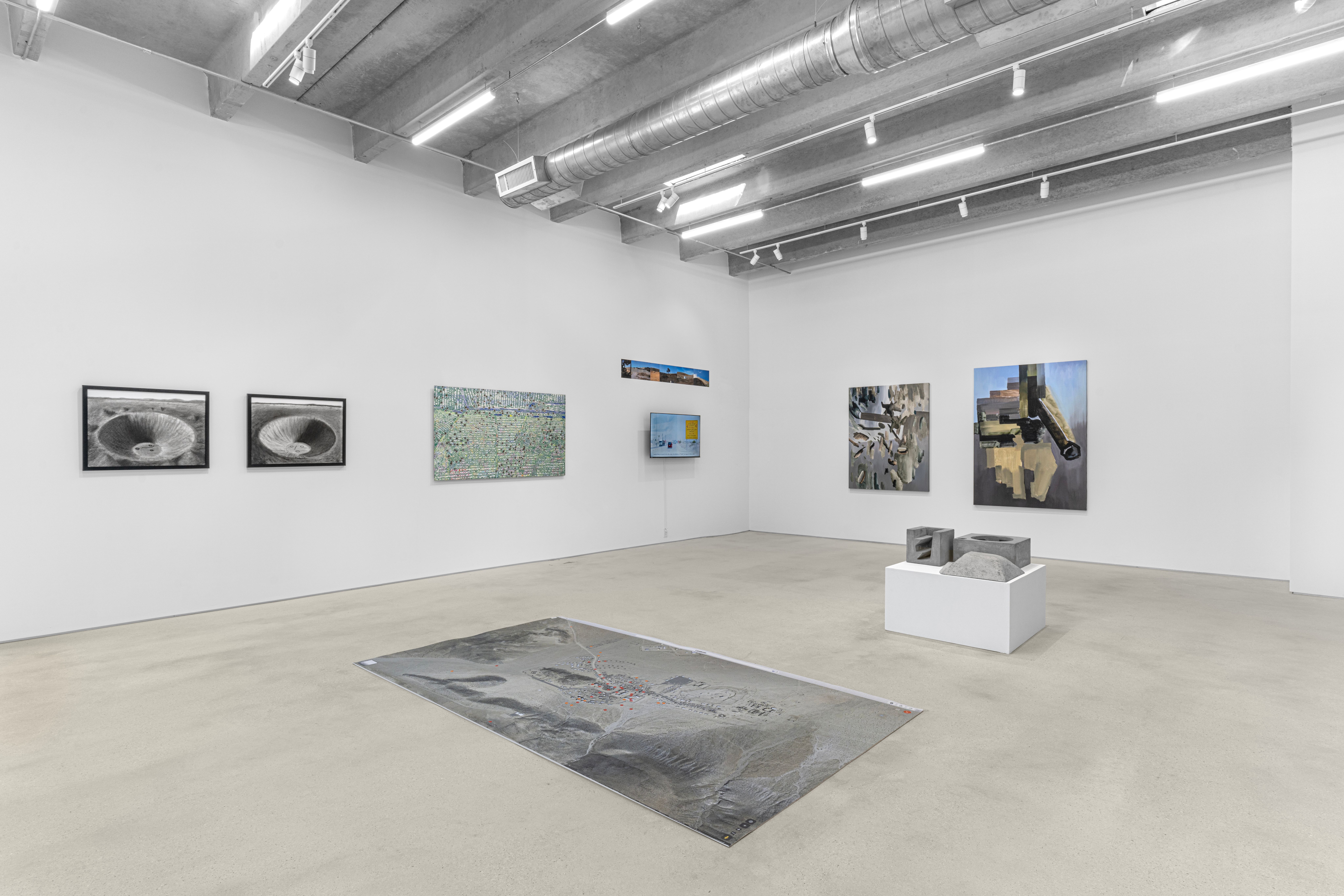 Contemporary art gallery interior with diverse range of artworks.