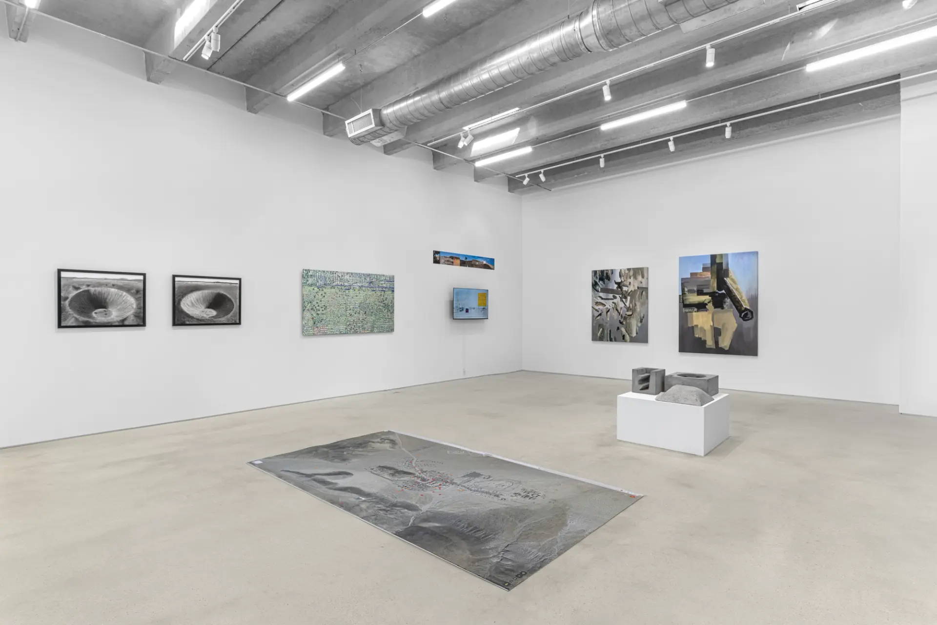 Contemporary art gallery interior with diverse range of artworks.