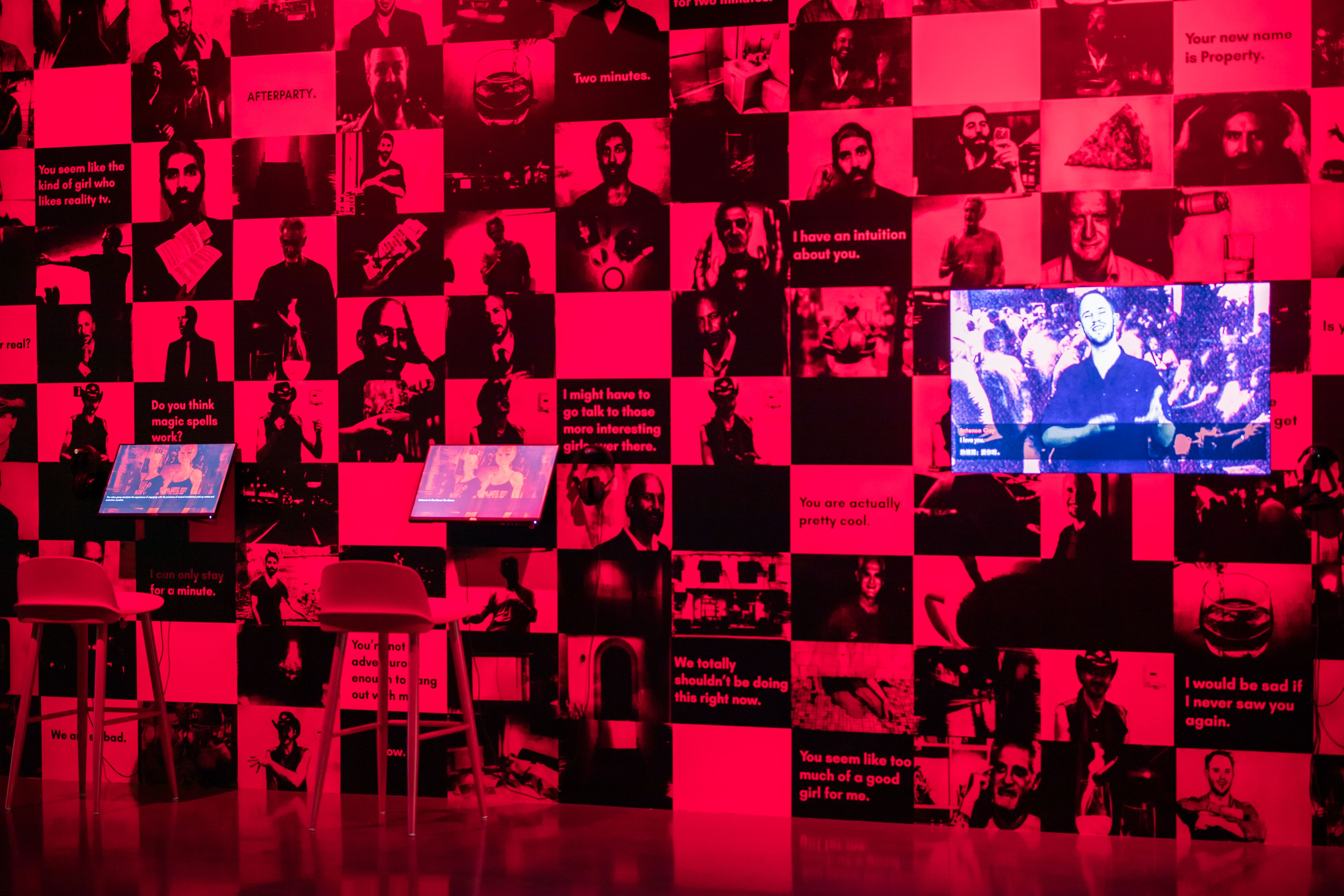Vibrant red room with walls covered in photos and text-based art.