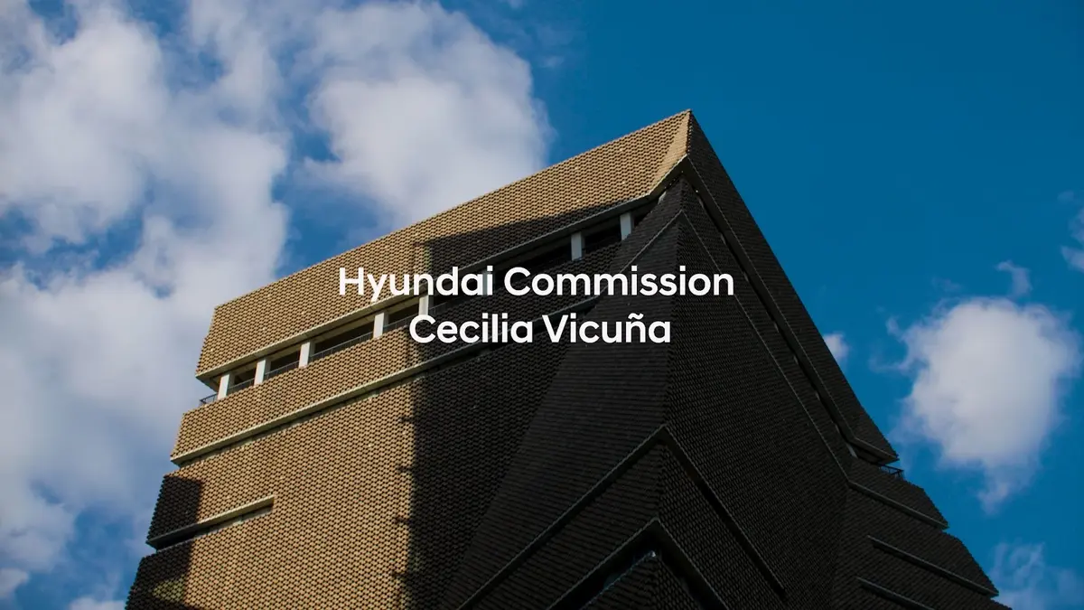A brown building under a cloudy blue sky overlaid with text, "Hyundai Commission: Cecilia Vicuña."