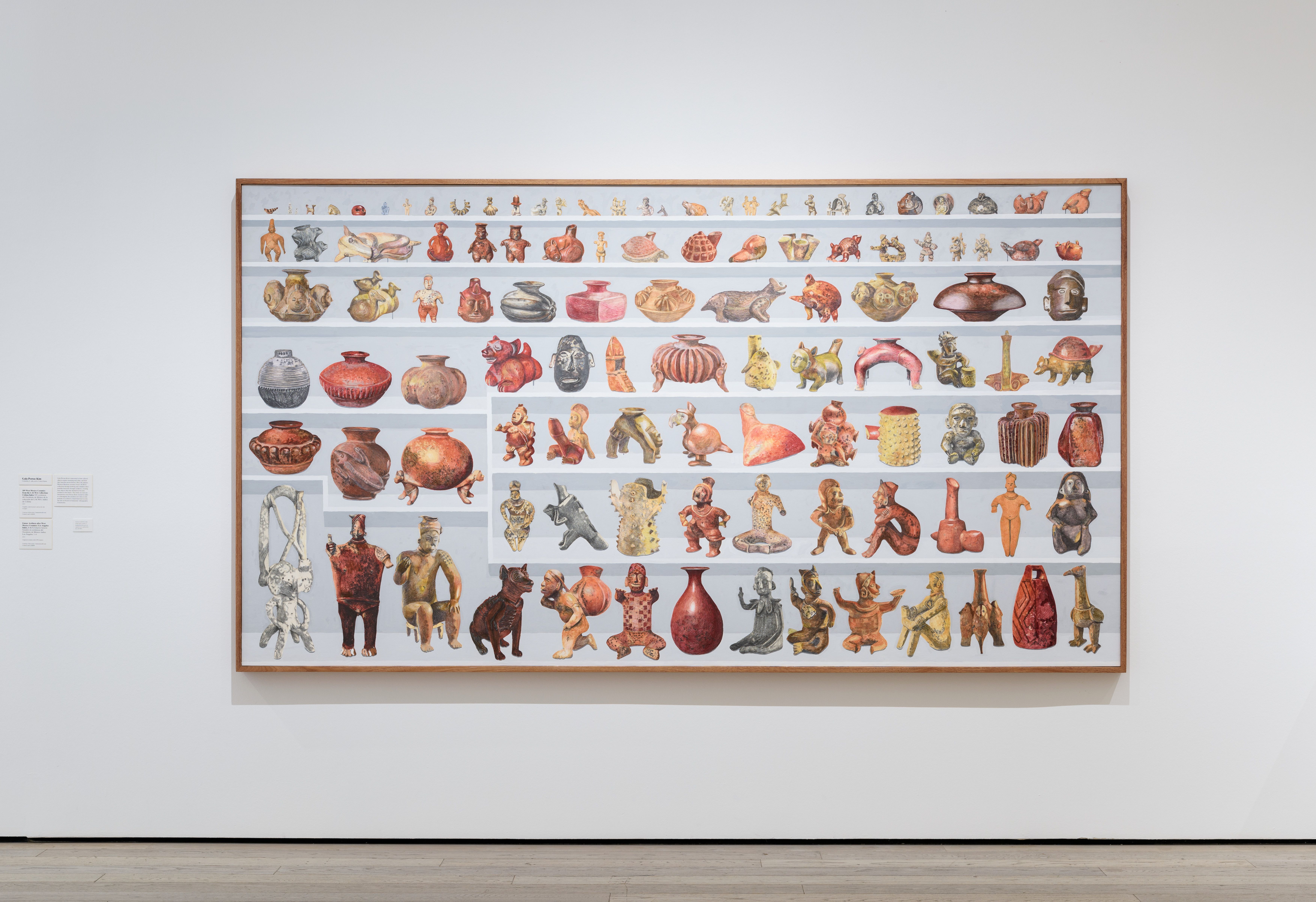 A framed artwork displaying rows of colorful ceramic animal figures and pottery.