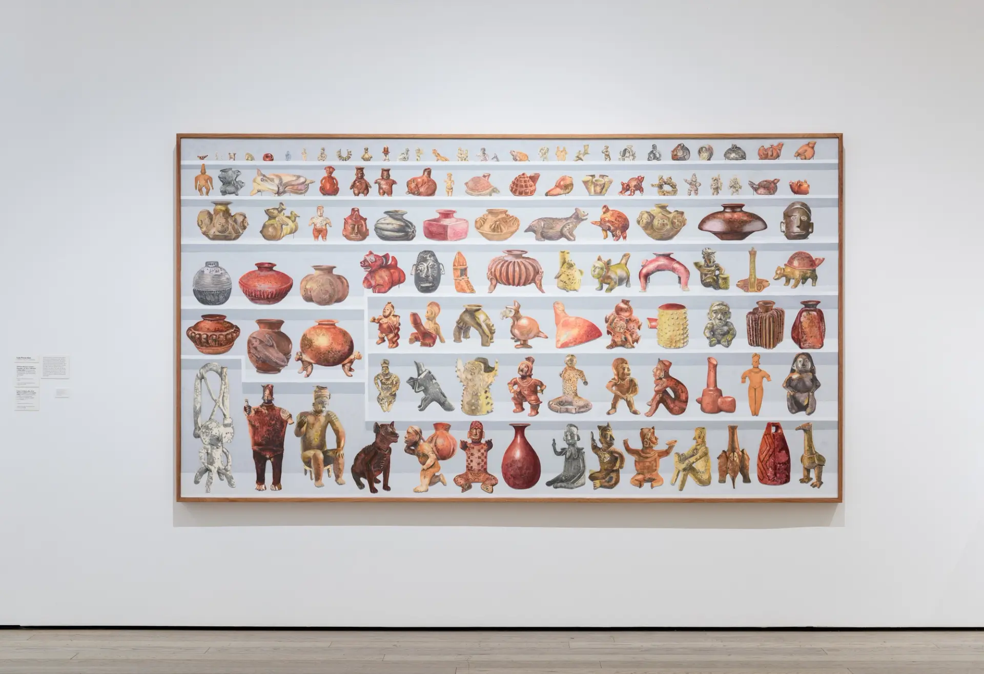 A framed artwork displaying rows of colorful ceramic animal figures and pottery.