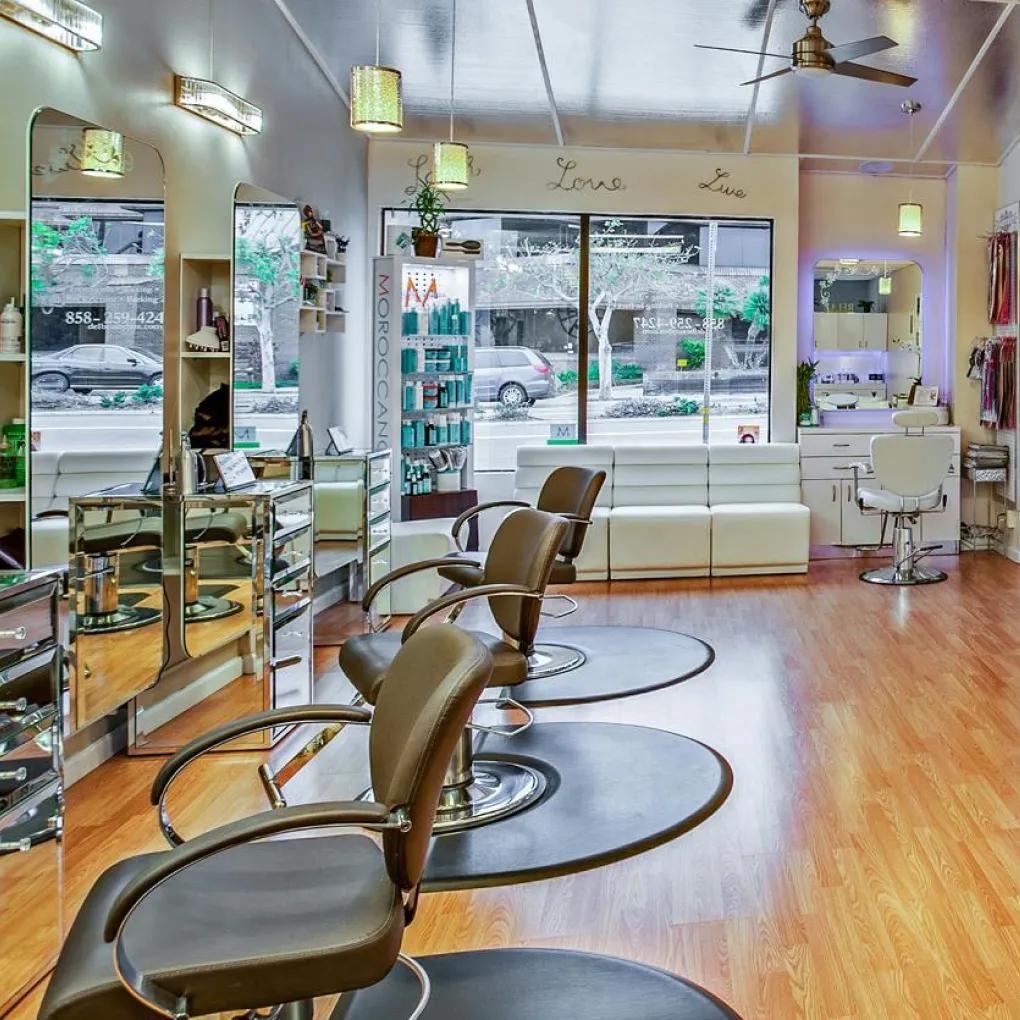 Modern hair salon interior featuring styling stations and retail area managed by professional salon answering service