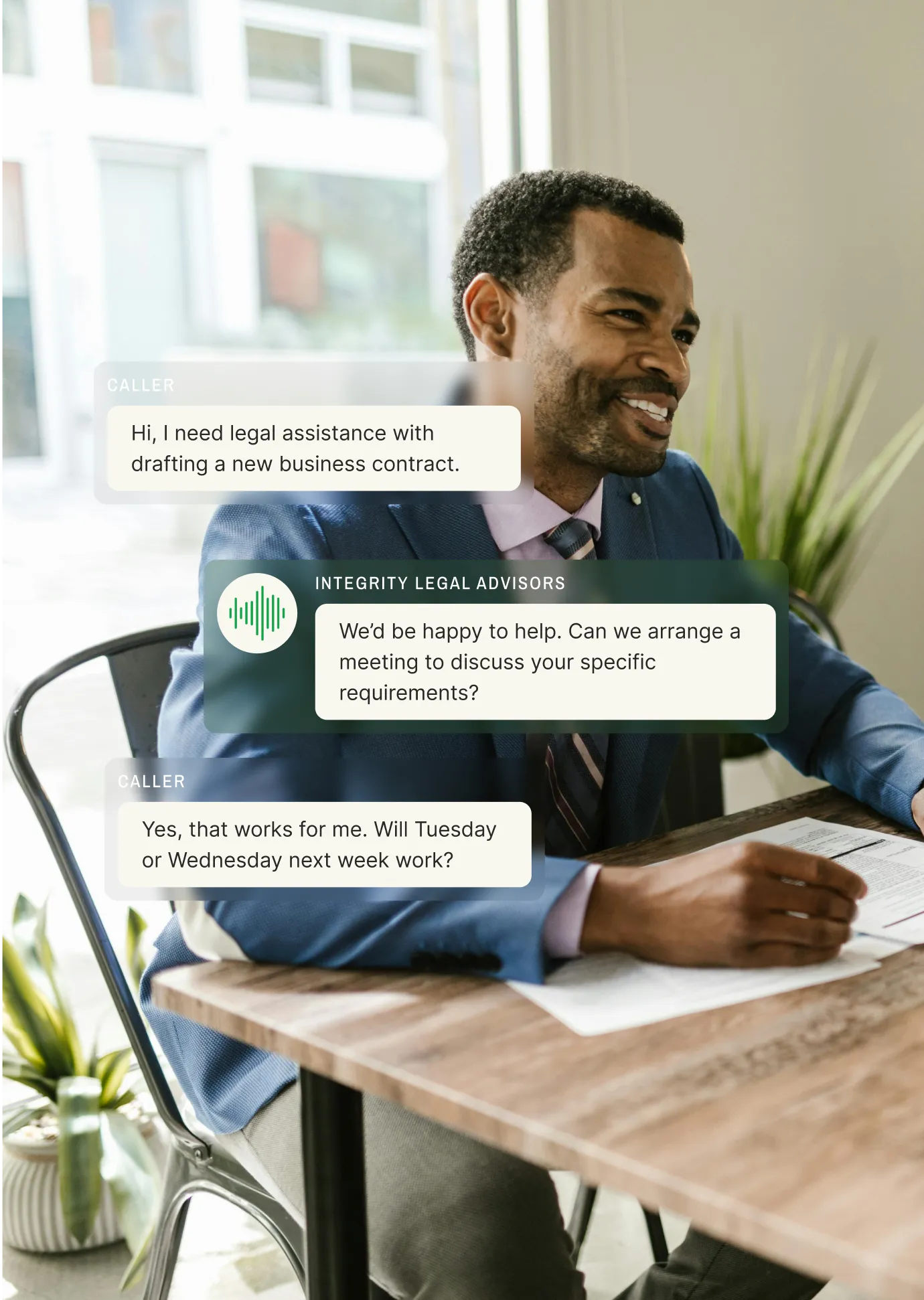 A professional man in a suit sits at a desk discussing legal services, highlighting how a business voicemail service streamlines client communication.