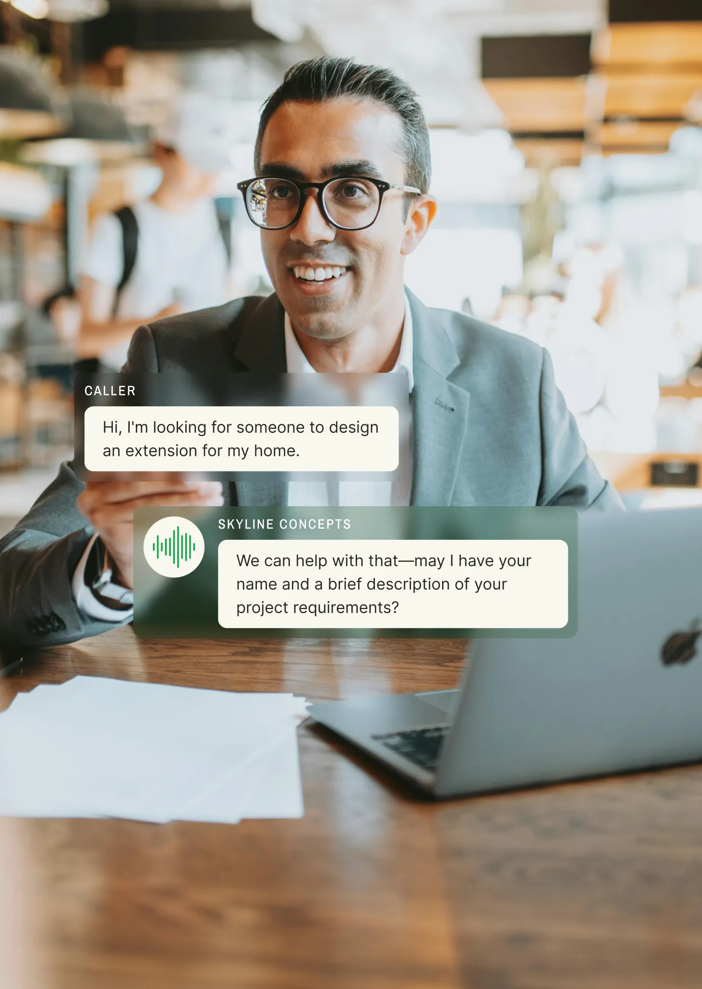 A business professional in a café smiles while using a laptop, with an AI voice agent responding to a caller inquiring about home extension design, showcasing seamless AI call handling.