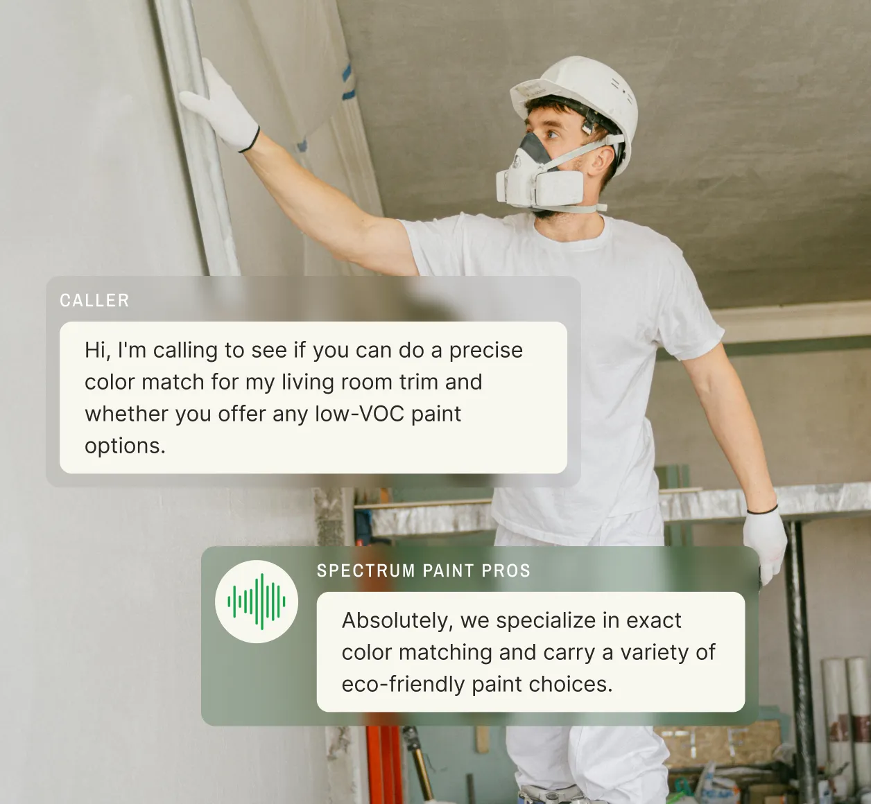 A professional painter wearing a respirator applies paint to a wall while transcribing a voice message about color matching and eco-friendly paint options using voicemail transcription services.