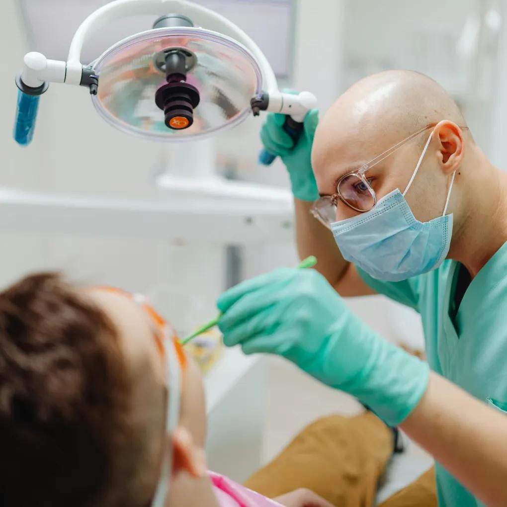 Dental professional using a tablet while handling appointment rescheduling through a dental office answering service