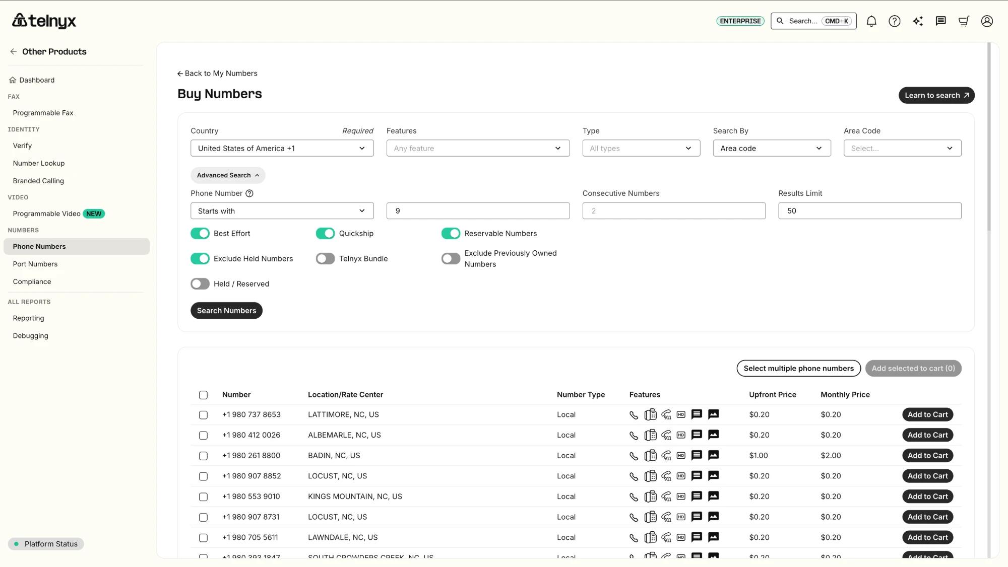 Telnyx's Buy Numbers screen, showing a search for US local phone numbers by country and area code, with upfront and monthly prices for each number