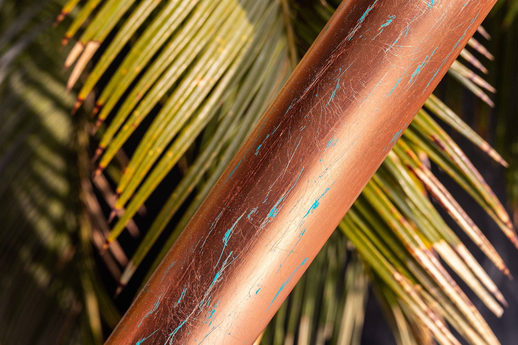 Copper tube detail with teal paint