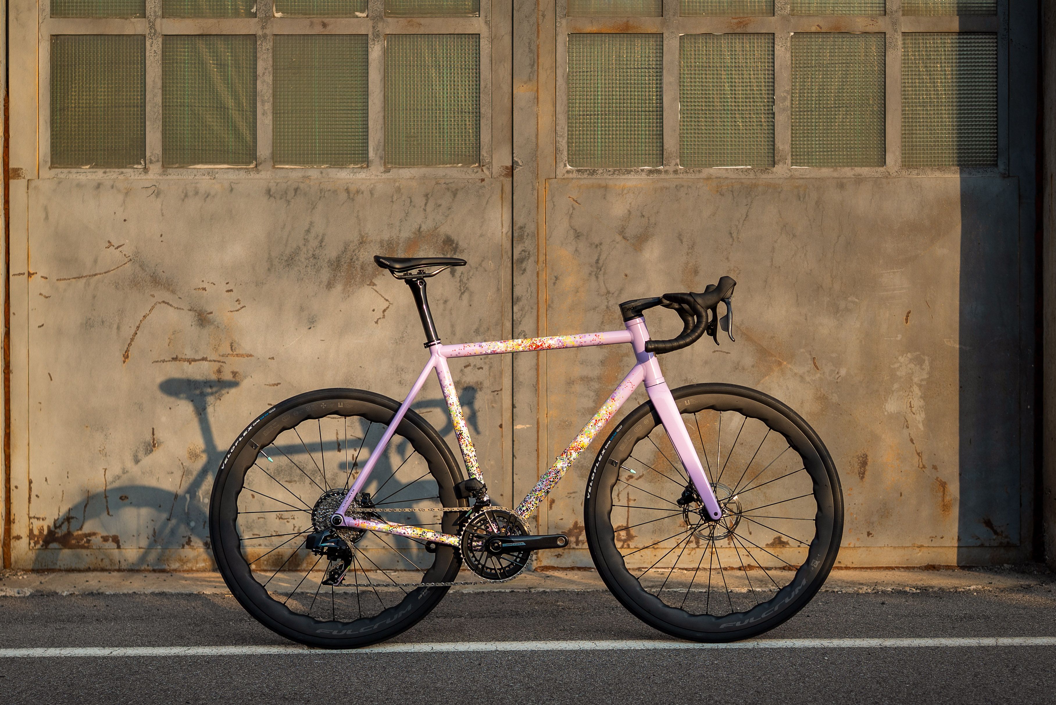 Pegoretti Love #3 leaning against the workshop doors