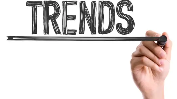 Hand with marker writing the word Trends.jpeg