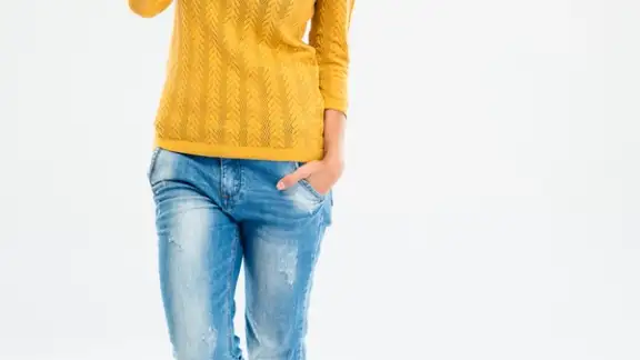 Full length portrait of a happy young woman talking on the phone isolated on a white background.jpeg