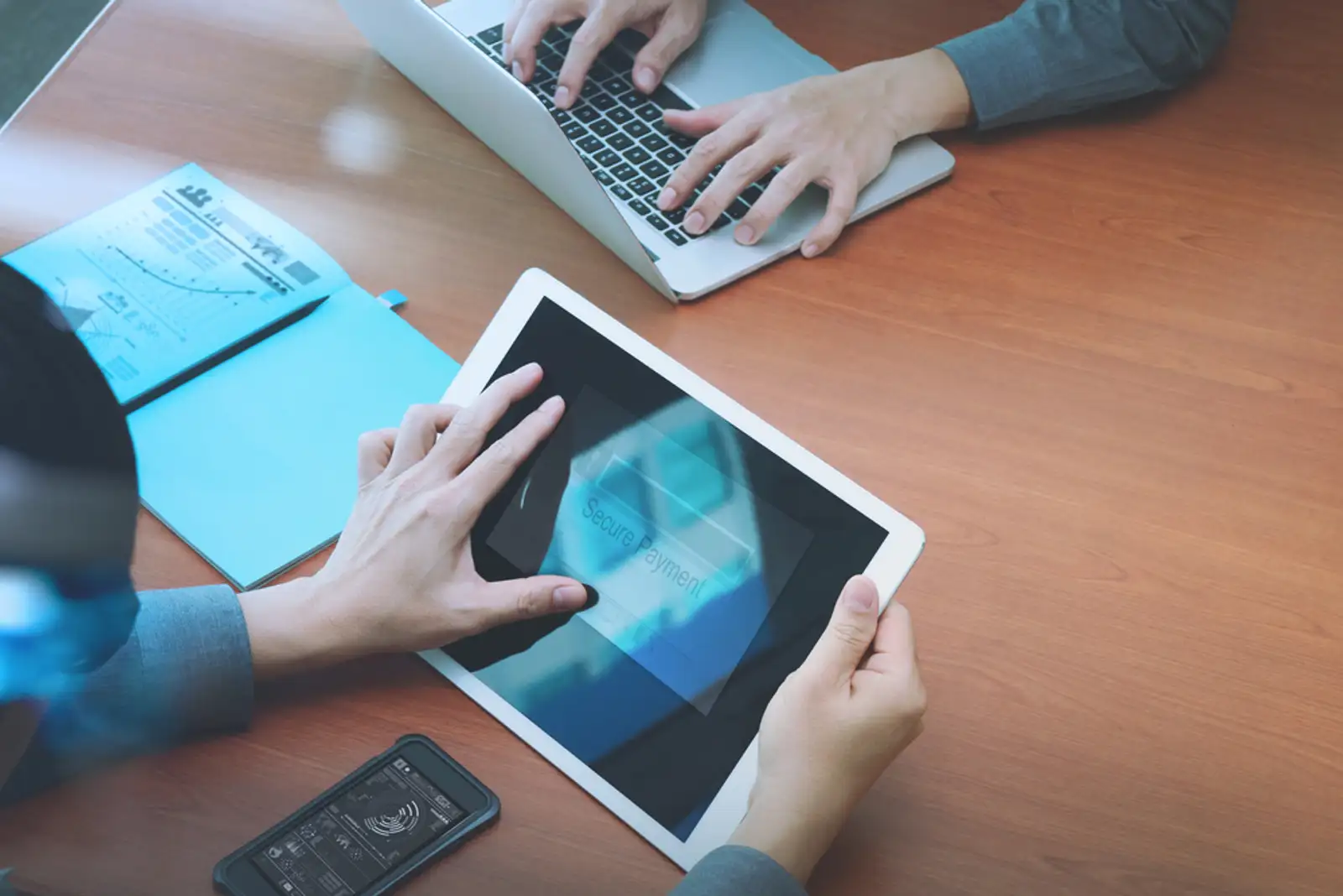 top view of two colleagues using digital pro tablet and laptop computer with Secure payment on the screen as Online shopping concept.jpeg
