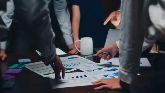 businessmen in piedi davanti ad un progetto cartaceo.jpg