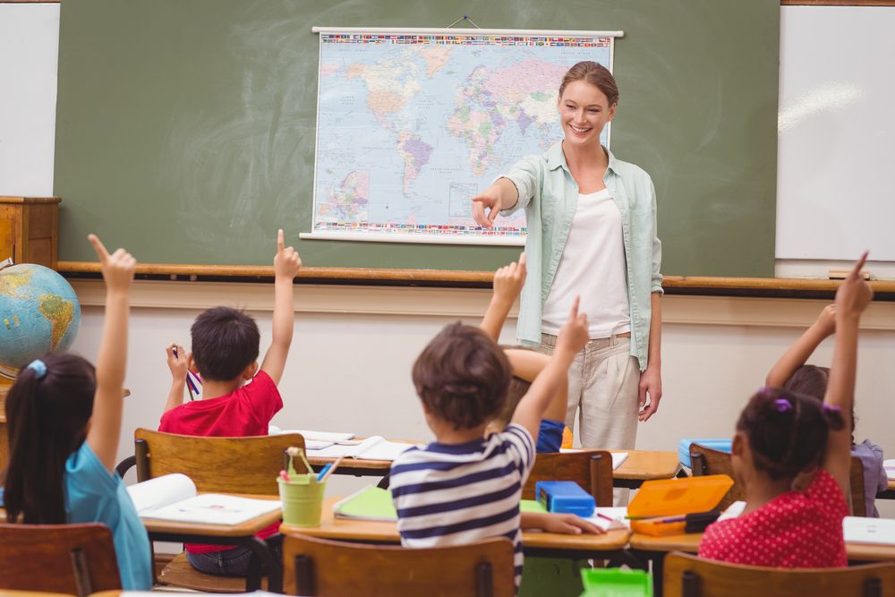 Pupils raising hand in classroom at the elementary school.jpeg