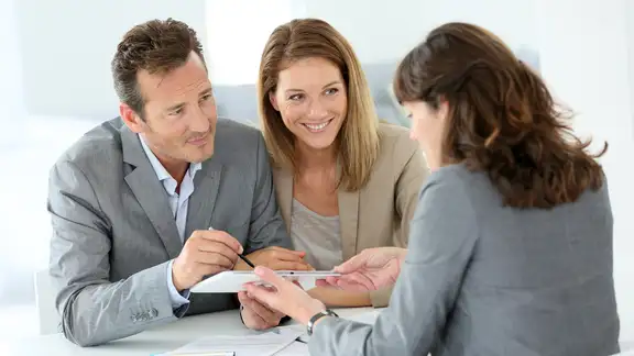 Couple signing loan grant on digital tablet.jpeg
