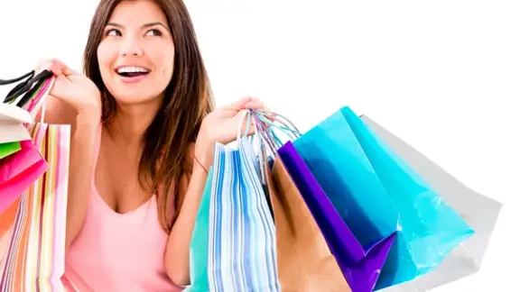 Happy shopping woman smiling - isolated over white background.jpeg