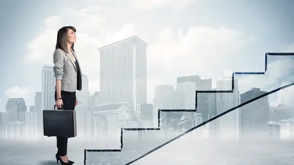 Business person in front of a staircase%2c city on the background.jpeg