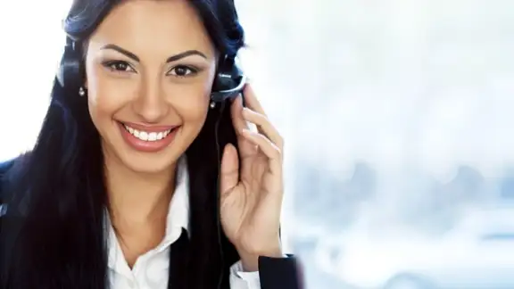 Female customer support operator with headset and smiling.jpeg