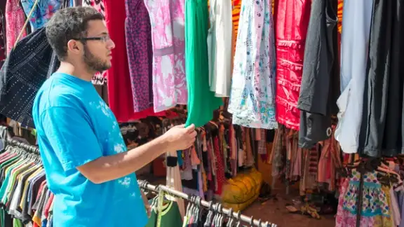 Young man buying in second hand store.jpeg